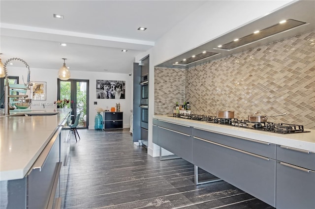 1601 Diplomat Pkwy, Hollywood, FL 33019 - kitchen featuring gray cabinetry, decorative backsplash, dark wood finished floors, light countertops, and recessed lighting
