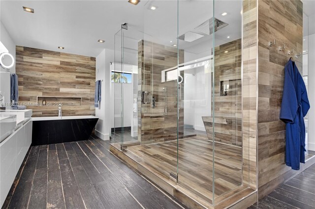 1601 Diplomat Pkwy, Hollywood, FL 33019 - full bathroom featuring wood-type flooring, a freestanding bath, a stall shower, vanity, and wooden walls
