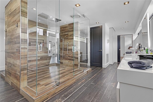 1601 Diplomat Pkwy, Hollywood, FL 33019 - full bathroom featuring vanity, a shower stall, hardwood / wood-style floors, baseboards, and recessed lighting
