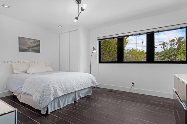 1601 Diplomat Pkwy, Hollywood, FL 33019 - bedroom with multiple windows, baseboards, and dark wood-style floors