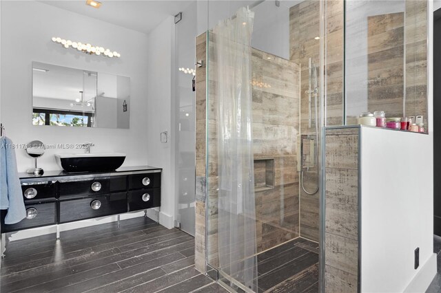 1601 Diplomat Pkwy, Hollywood, FL 33019 - bathroom with vanity, a shower stall, and wood finished floors