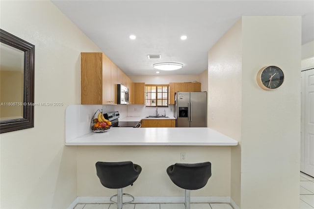 6755 NW 182nd St Unit 104, Hialeah, FL 33015 - kitchen featuring appliances with stainless steel finishes, light countertops, a peninsula, a sink, and recessed lighting