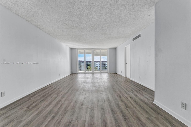 2525 Florida Blvd Unit 530, Delray Beach, FL 33483 - spare room with a textured ceiling, floor to ceiling windows, and wood finished floors