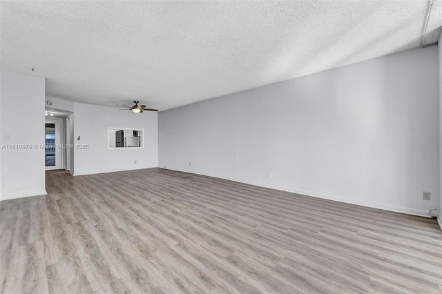 2525 Florida Blvd Unit 530, Delray Beach, FL 33483 - unfurnished living room with a textured ceiling, a ceiling fan, and wood finished floors
