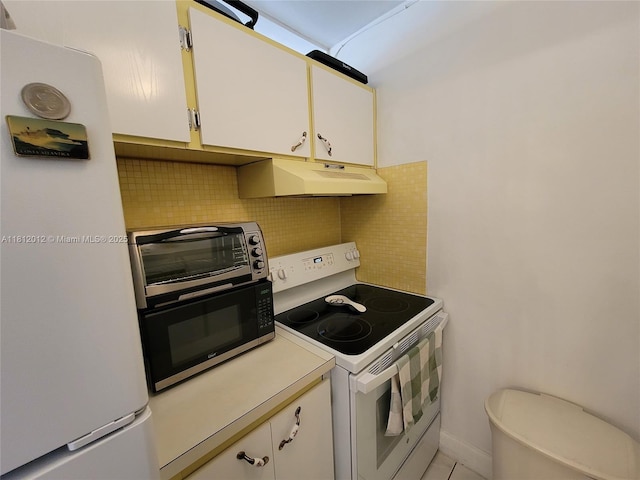 15600 NE 6th Ave Unit 33A, Miami, FL 33162 - kitchen featuring white appliances, under cabinet range hood, tasteful backsplash, light countertops, and white cabinets