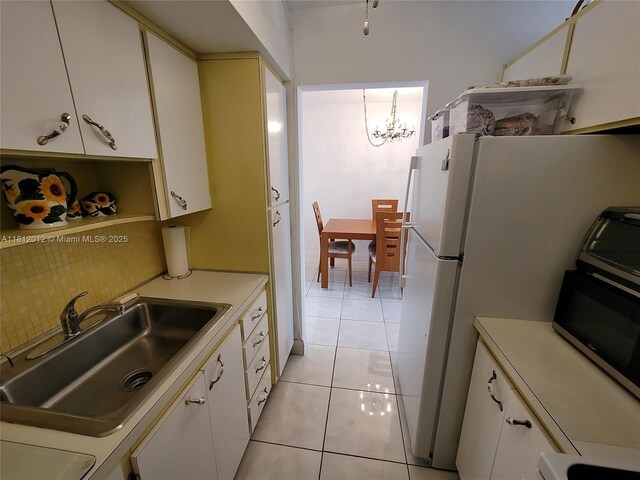 15600 NE 6th Ave Unit 33A, Miami, FL 33162 - kitchen with a sink, light countertops, a chandelier, and light tile patterned floors