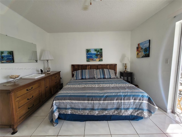 15600 NE 6th Ave Unit 33A, Miami, FL 33162 - bedroom featuring light tile patterned flooring and a textured ceiling