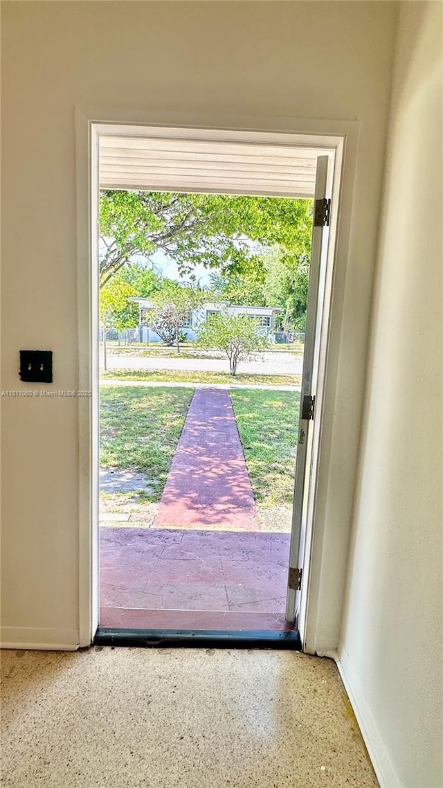 580 NE 139th St, North Miami, FL 33161 - entryway with baseboards and speckle patterned floor
