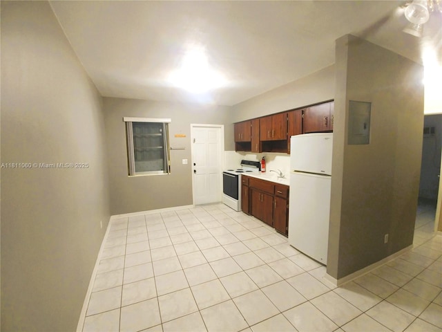 580 NE 139th St, North Miami, FL 33161 - kitchen featuring white appliances, light countertops, light tile patterned flooring, baseboards, and a sink