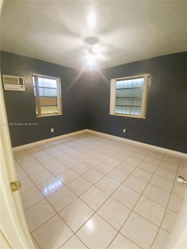 580 NE 139th St, North Miami, FL 33161 - unfurnished room featuring a ceiling fan, light tile patterned floors, and an AC wall unit