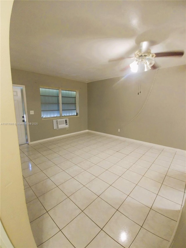 580 NE 139th St, North Miami, FL 33161 - unfurnished room featuring light tile patterned floors, a ceiling fan, a wall mounted air conditioner, and baseboards