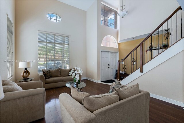 1724 SW 154th Path, Miami, FL 33185 - living area featuring stairs, a towering ceiling, healthy amount of natural light, and wood finished floors