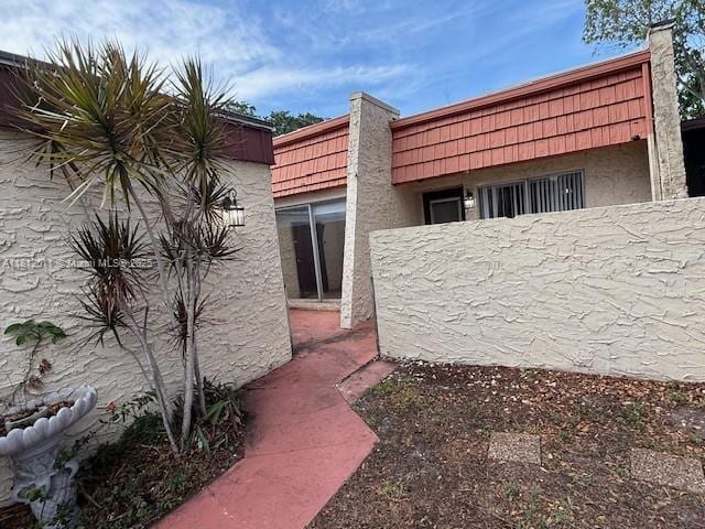 9423 NW 65th St Unit E2, Tamarac, FL 33321 - view of side of home with stucco siding
