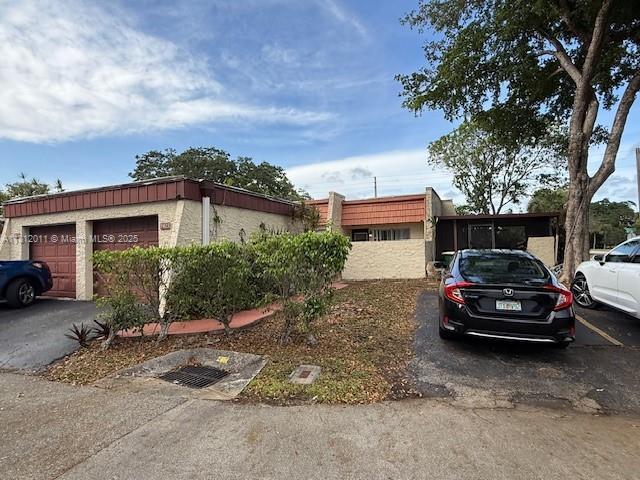 9423 NW 65th St Unit E2, Tamarac, FL 33321 - view of front of home featuring a garage