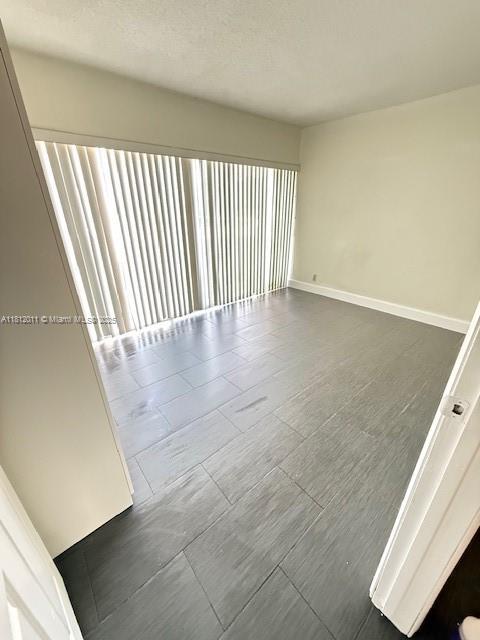 9423 NW 65th St Unit E2, Tamarac, FL 33321 - spare room with baseboards