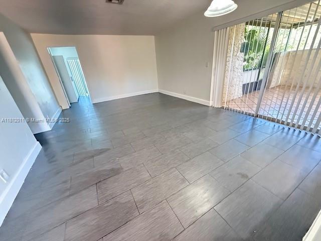 9423 NW 65th St Unit E2, Tamarac, FL 33321 - unfurnished room featuring baseboards