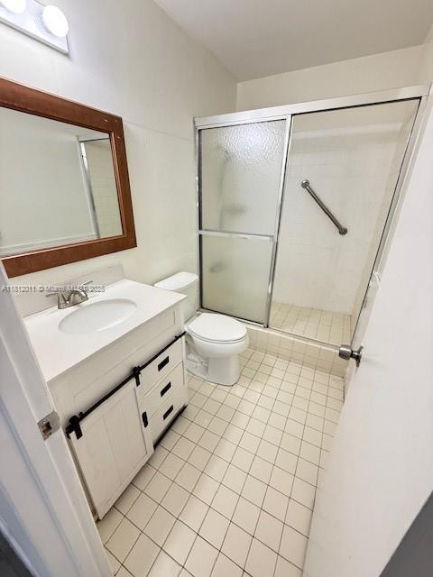 9423 NW 65th St Unit E2, Tamarac, FL 33321 - full bathroom featuring vanity, tile patterned floors, toilet, and a stall shower