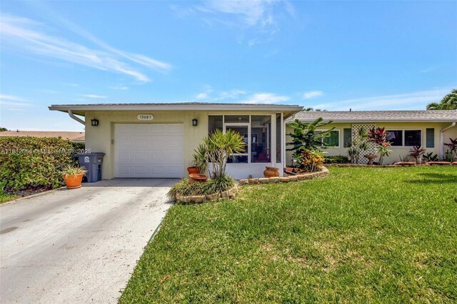 13097 Via Minerva, Delray Beach, FL 33484 - single story home featuring a garage, driveway, a sunroom, and a front yard