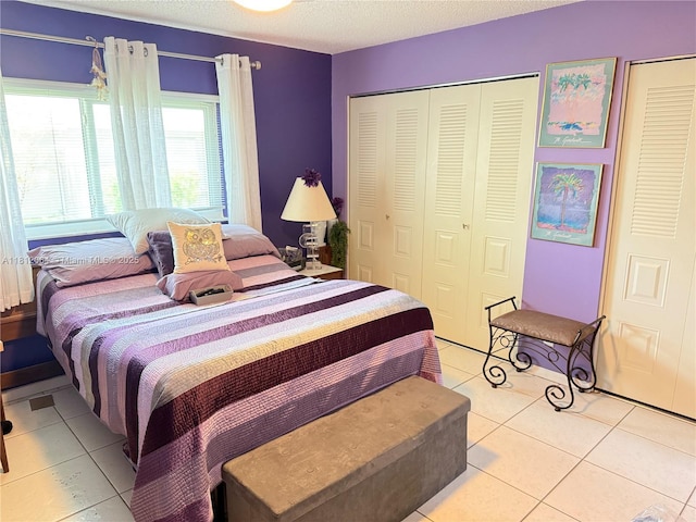 13097 Via Minerva, Delray Beach, FL 33484 - bedroom with light tile patterned floors, a textured ceiling, and a closet