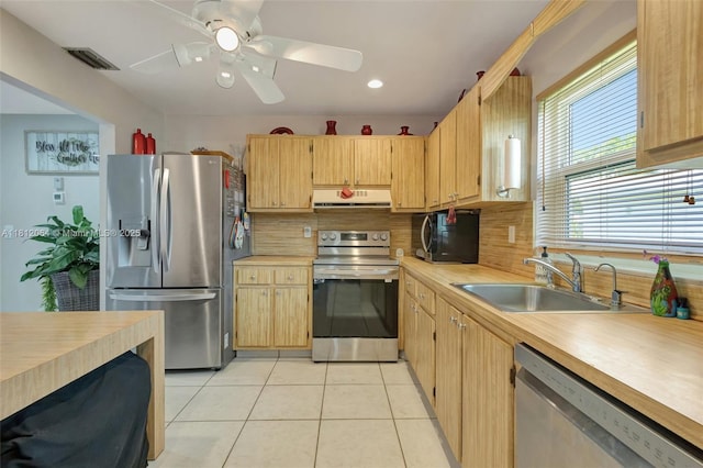 13097 Via Minerva, Delray Beach, FL 33484 - kitchen with stainless steel appliances, a sink, light countertops, light tile patterned floors, and range hood