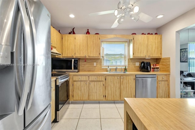 13097 Via Minerva, Delray Beach, FL 33484 - kitchen featuring stainless steel appliances, light countertops, a sink, backsplash, and light tile patterned flooring