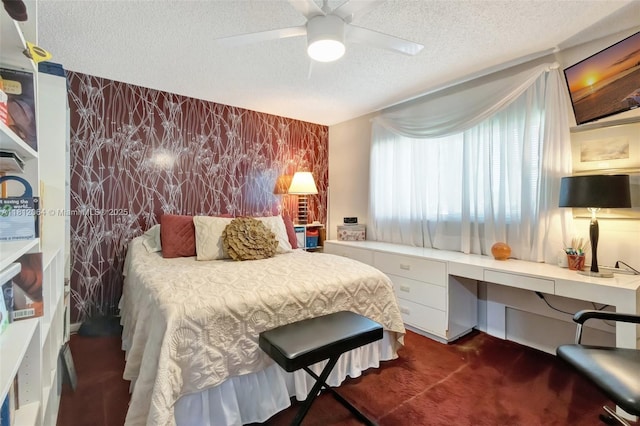13097 Via Minerva, Delray Beach, FL 33484 - bedroom featuring a textured ceiling, an accent wall, dark carpet, and a ceiling fan