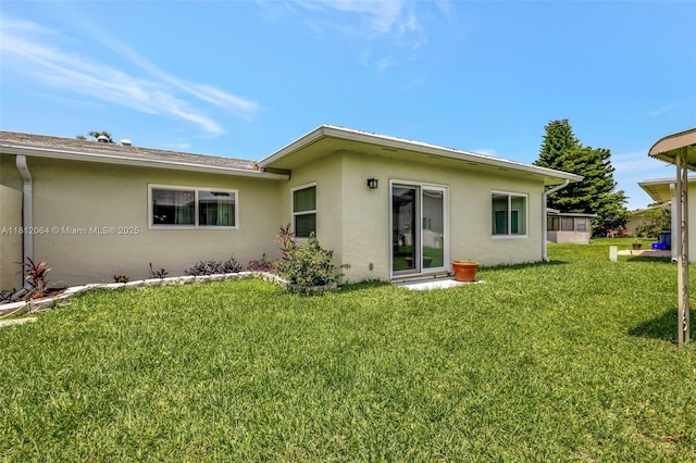 13097 Via Minerva, Delray Beach, FL 33484 - back of house with stucco siding and a yard