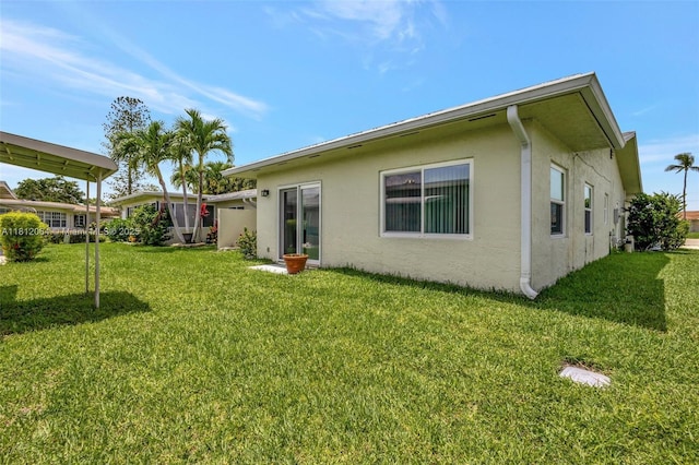 13097 Via Minerva, Delray Beach, FL 33484 - back of house featuring stucco siding and a lawn