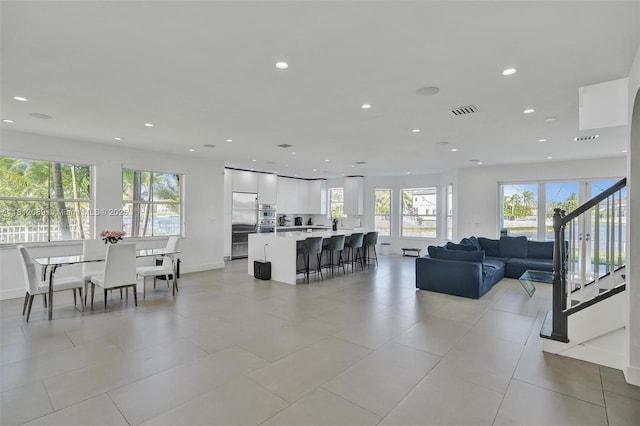 16880 SW 49th Ct, Miramar, FL 33027 - living room with plenty of natural light, recessed lighting, light tile patterned flooring, stairs, and baseboards