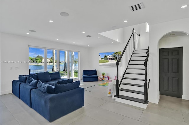 16880 SW 49th Ct, Miramar, FL 33027 - living room featuring arched walkways, a water view, recessed lighting, stairs, and light tile patterned floors