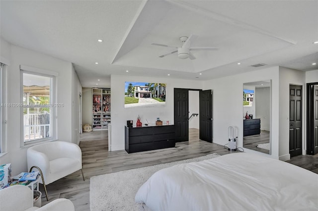 16880 SW 49th Ct, Miramar, FL 33027 - bedroom featuring light wood finished floors, recessed lighting, baseboards, a tray ceiling, and ceiling fan