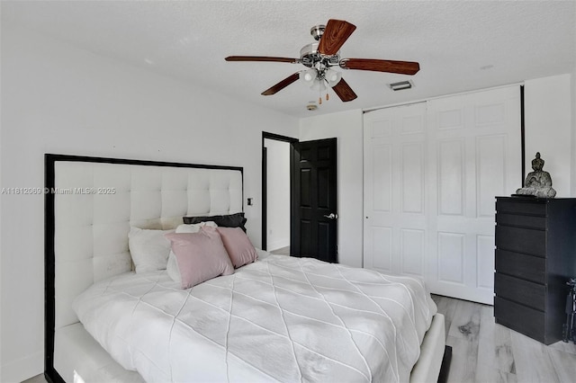 16880 SW 49th Ct, Miramar, FL 33027 - bedroom featuring a closet, ceiling fan, a textured ceiling, and wood finished floors