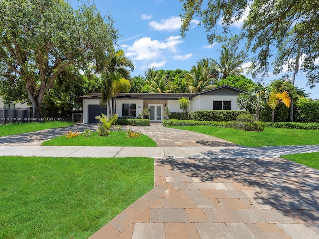 12531 SW 37th Ter, Miami, FL 33175 - ranch-style house with driveway, french doors, a garage, and stucco siding