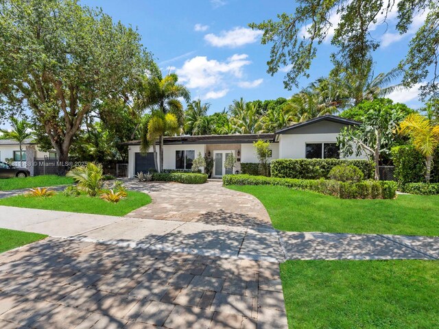 12531 SW 37th Ter, Miami, FL 33175 - ranch-style home featuring driveway, stucco siding, a garage, and french doors