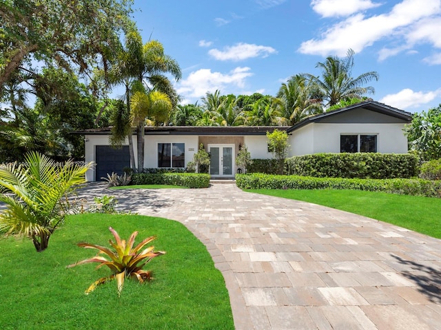 12531 SW 37th Ter, Miami, FL 33175 - ranch-style home featuring french doors, stucco siding, a front lawn, and driveway