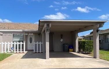6720 Moonlit Dr, Delray Beach, FL 33446 - view of front of home with concrete driveway and an attached carport
