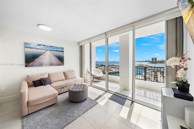 555 NE 15th St Unit 516, Miami, FL 33132 - tiled living area with a water view, expansive windows, and baseboards