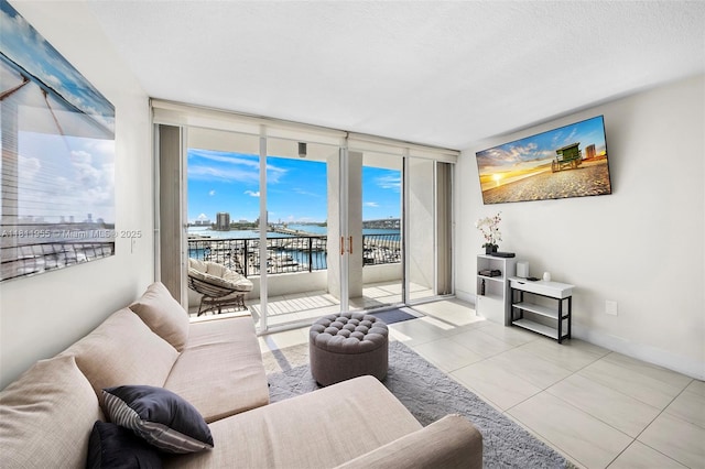 555 NE 15th St Unit 516, Miami, FL 33132 - tiled living area with floor to ceiling windows and baseboards