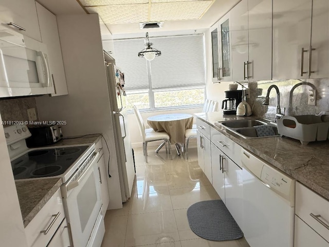 18051 Biscayne Blvd Unit 1505, Aventura, FL 33160 - kitchen featuring white appliances, a sink, tasteful backsplash, and white cabinetry