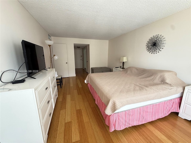 18051 Biscayne Blvd Unit 1505, Aventura, FL 33160 - bedroom featuring light wood-style flooring and a textured ceiling