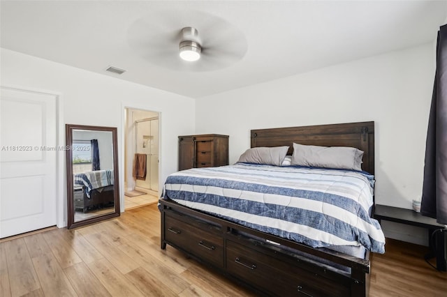 579 NE 6th Pl, Florida City, FL 33034 - bedroom with light wood-type flooring, ceiling fan, and connected bathroom
