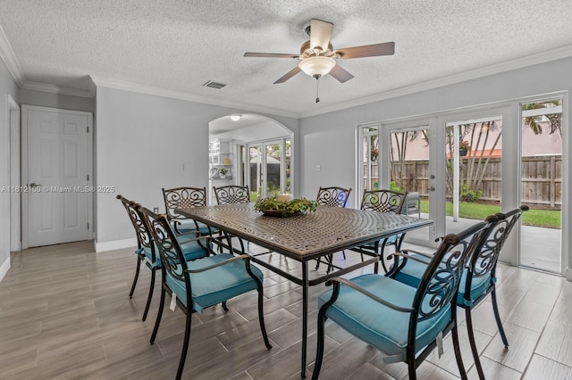 7251 SW 158th Pl, Miami, FL 33193 - dining room featuring ceiling fan, light wood finished floors, arched walkways, french doors, and plenty of natural light