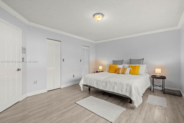 7251 SW 158th Pl, Miami, FL 33193 - bedroom with two closets, wood finished floors, crown molding, and a textured ceiling