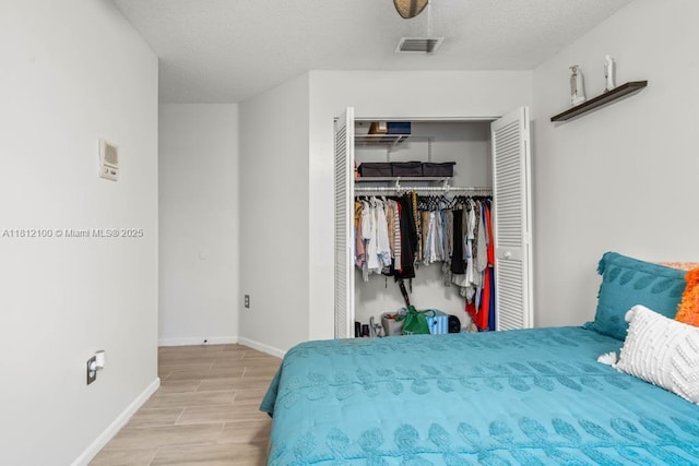 7251 SW 158th Pl, Miami, FL 33193 - bedroom with a closet, wood tiled floors, and a textured ceiling