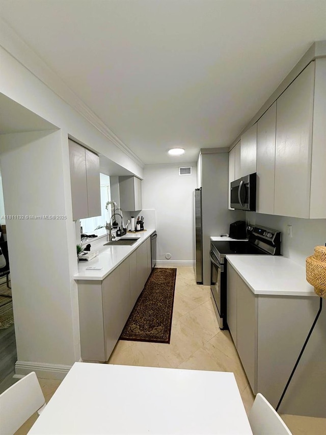 4730 NW 97th Ct Unit 76, Doral, FL 33178 - kitchen with appliances with stainless steel finishes, a sink, light countertops, gray cabinets, and baseboards