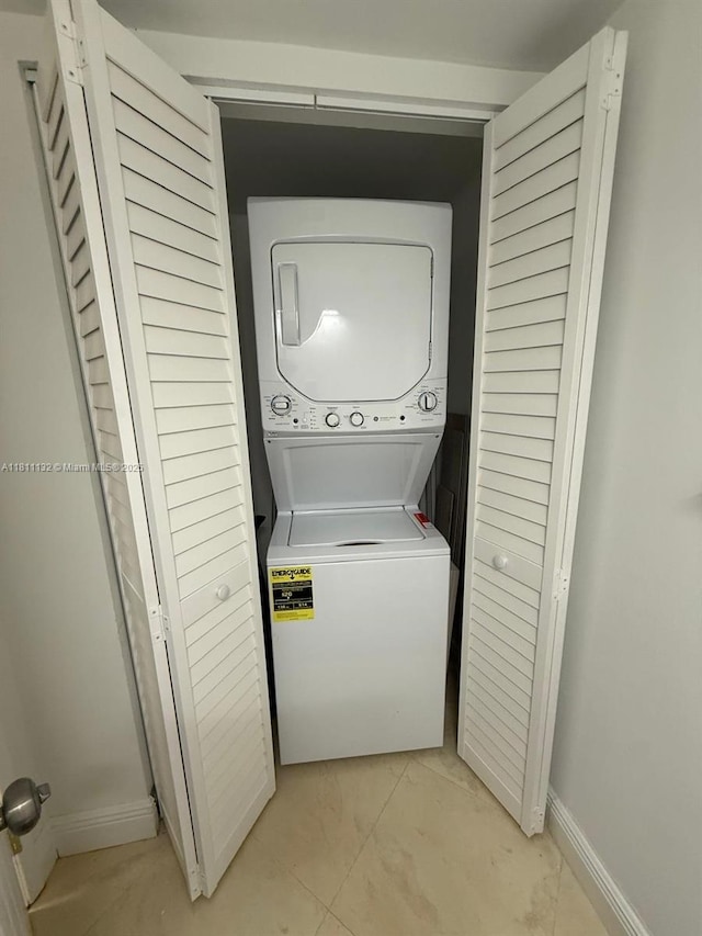 4730 NW 97th Ct Unit 76, Doral, FL 33178 - laundry area with stacked washer and clothes dryer and baseboards
