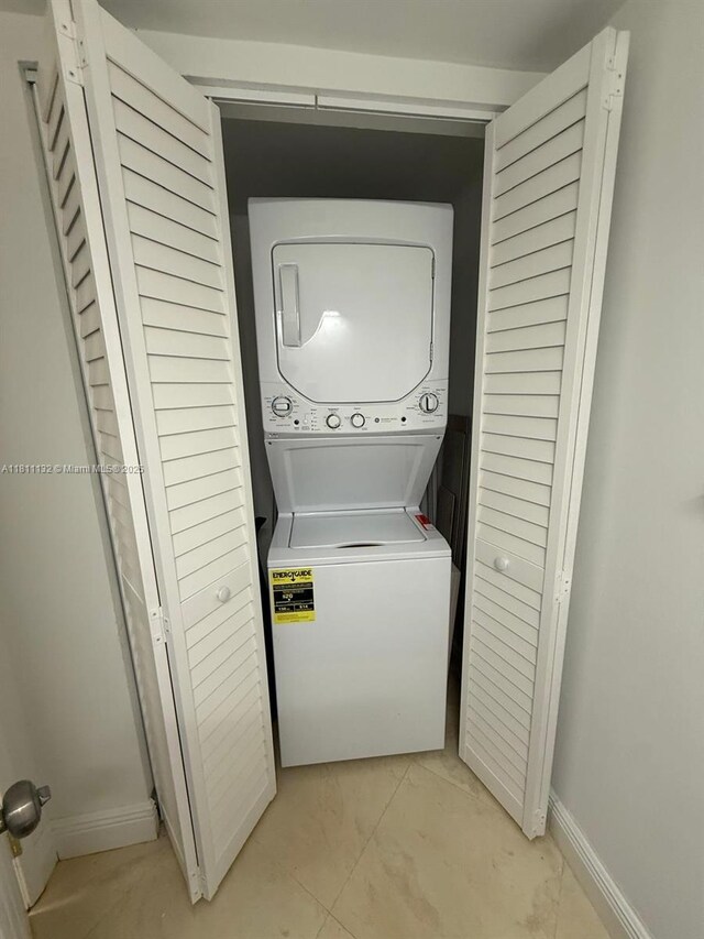 4730 NW 97th Ct Unit 76, Doral, FL 33178 - laundry area featuring stacked washer / drying machine and baseboards
