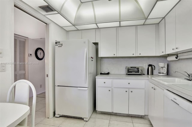 3091 N Course Dr Unit 502, Pompano Beach, FL 33069 - kitchen with white appliances, light countertops, light tile patterned flooring, and a sink