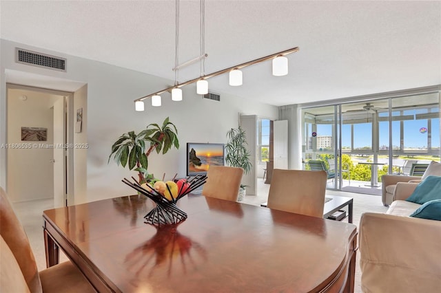3091 N Course Dr Unit 502, Pompano Beach, FL 33069 - dining space featuring a ceiling fan and a wall of windows