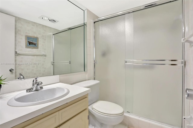 3091 N Course Dr Unit 502, Pompano Beach, FL 33069 - full bathroom featuring vanity, a shower stall, toilet, and tile walls